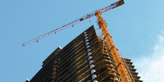 A crane and skyscraper building under construction
